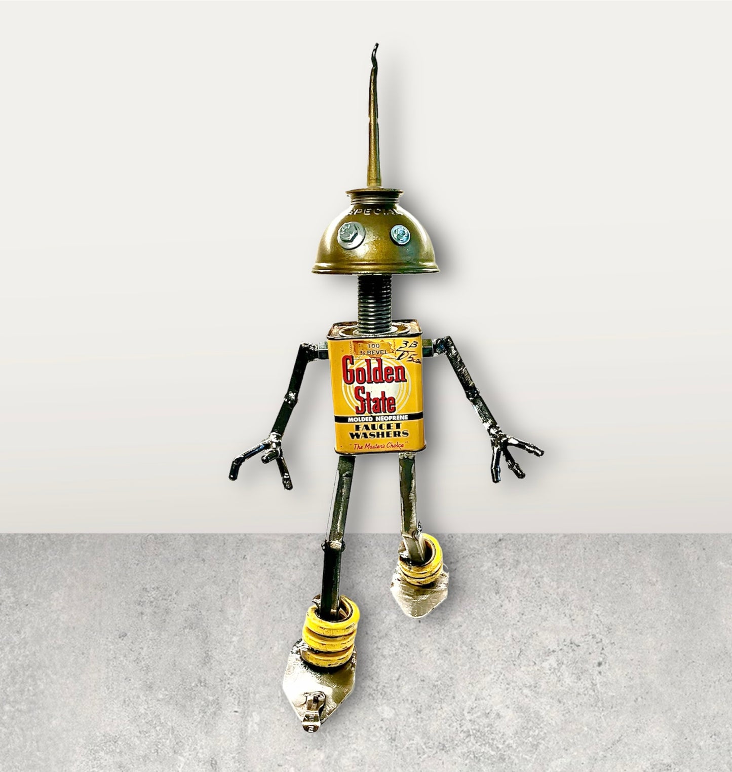 Meet Special! This one-of-a-kind robot scrap art sculpture is made from a vintage Golden State Faucet Washer tin body, a vintage Special oiler head and scrap metal arms and legs. Spruce up any shelf in your home or office with this bright and cheery robot sculpture.