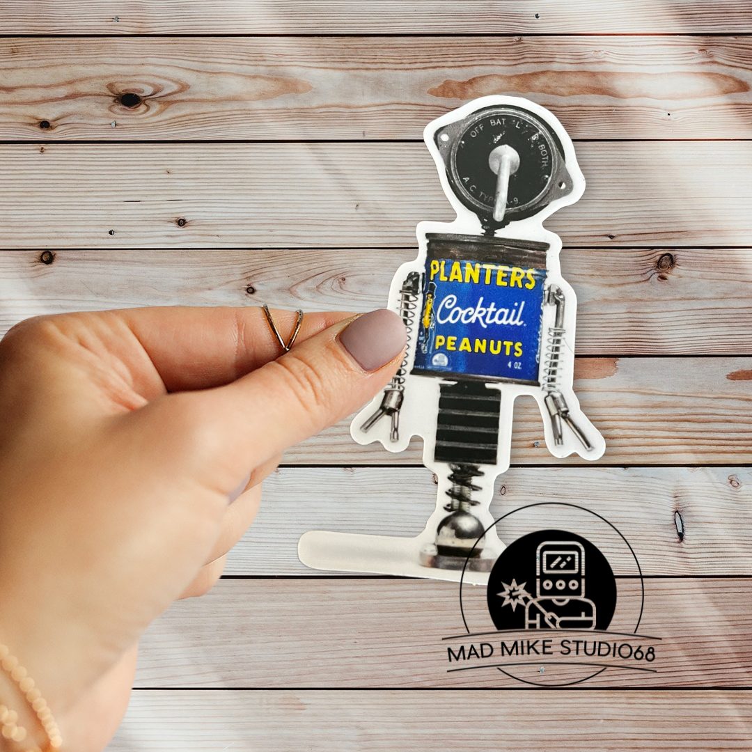 This cute little custom die cut robot scrap art sticker is made of permanent white semi gloss vinyl and measures as follows: Features: Metric: 5 cm wide x 8.5 cm tall Imperial: 2 inches wide x 3.5 inches tall Collect them all!