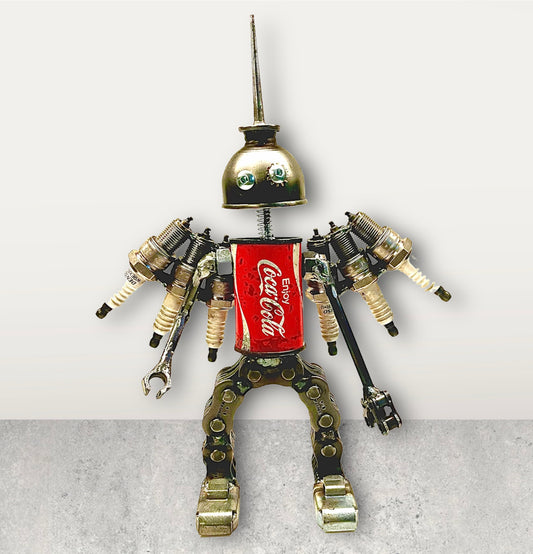 Meet Denso!  This one-of-a-kind robot scrap art sculpture is made from a vintage Coca-Cola salt shaker tin body, a vintage oiler head, scrap metal arms and legs and spark plug wings. Spruce up any shelf in your home or office with this iconic and well known trademark robot sculpture.  