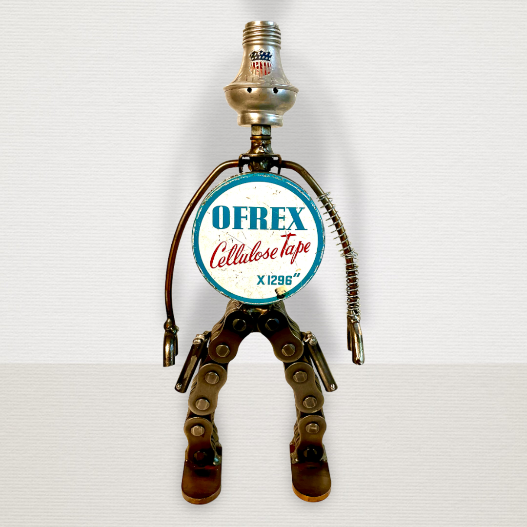 Meet Rex!  This one-of-a-kind robot scrap art sculpture is made from a vintage round cellulose tape tin body, a commemorative USA tin salt shaker head, lamp parts and spring arms, industrial chain legs each strapped with a pistol ready for action. Spruce up any shelf in your home or office with this super cool robot sculpture.  