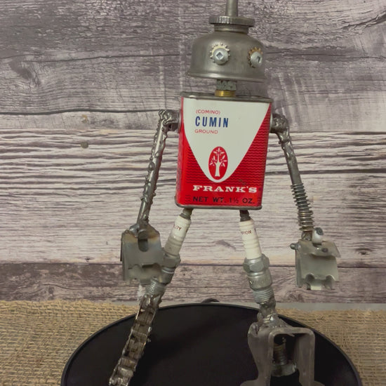 Meet Comino!  This one-of-a-kind robot scrap art sculpture is made from a vintage cumin (comino) spice tin body, a vintage oiler head, scrap metal arms, spark plug thighs with scrap metal legs and feet. Spice up any shelf in your home or office with this spicy robot sculpture.  