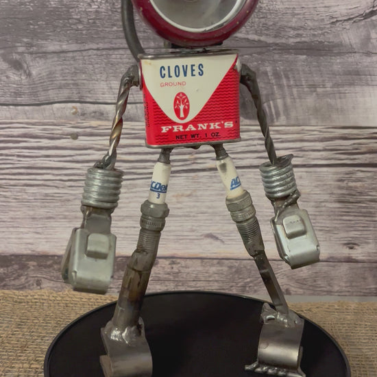 Meet Frankie!  This one-of-a-kind robot scrap art sculpture is made from a vintage clove spice tin body, an imperfectly perfect flashlight head, unique pincer hands, sparkplug thighs and scrap metal calves and feet. Spice up any shelf in your home or office with this flashy robot sculpture.  