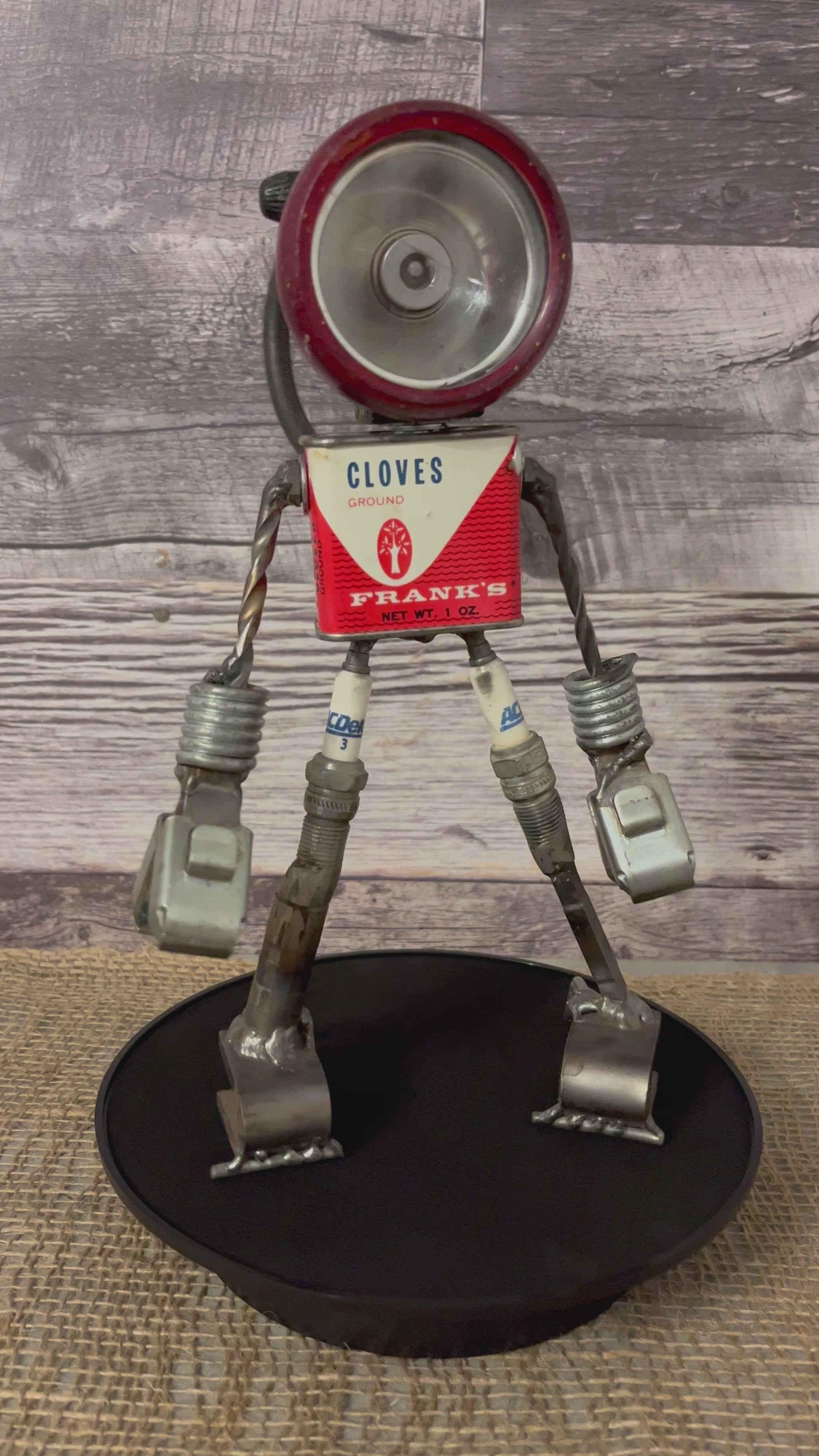 Meet Frankie!  This one-of-a-kind robot scrap art sculpture is made from a vintage clove spice tin body, an imperfectly perfect flashlight head, unique pincer hands, sparkplug thighs and scrap metal calves and feet. Spice up any shelf in your home or office with this flashy robot sculpture.  