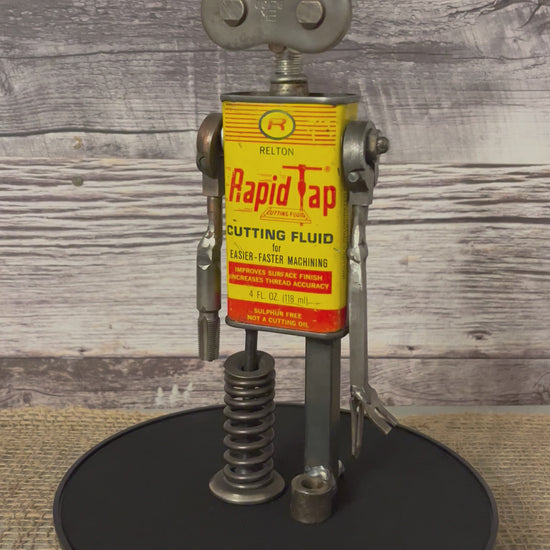 Meet Robby!  This one-of-a-kind robot scrap art sculpture is made from a vintage cutting fluid tin body, scrap metal head, uniquely reimagined singer sewing machine parts for arms and springy scrap metal legs. Spruce up any shelf in your home or office with this unique robot sculpture.  