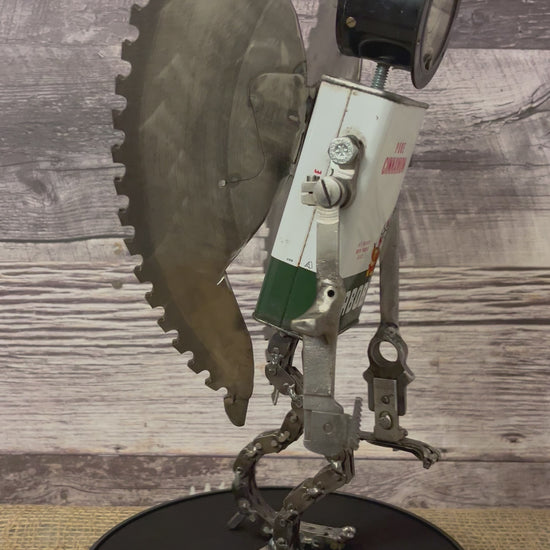 Meet Angel!  This one-of-a-kind robot scrap art sculpture is made from a vintage cinnamon tin body, vintage gauge head with uniquely reimagined scrap metal arms made from vintage Singer sewing machine parts, chain legs and saw blade wings.  Your very own guardian angel robot! See video for a 360-degree view! Features:  •	Height: 35 cm or 13.75 inches tall  •	Width: approximately 18 cm or 7 inches wide •	Weight: 1.17934 kg or 2.6 lbs.