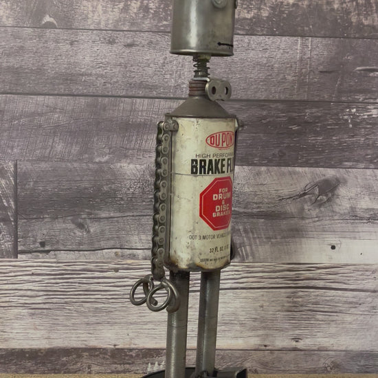 Meet Dupont! This one-of-a-kind robot scrap art sculpture is made from a vintage brake fluid oil tin body, vintage oiler head with uniquely reimagined scrap metal arms and legs.  This big guy is sure to turn heads and stop people in their tracks!  See video for a 360-degree view!  Features:   Height: 63 cm or 24.75 inches tall Width: approximately 15 cm or 6 inches wide Weight: 2.81227 kg or 6.2 lbs
