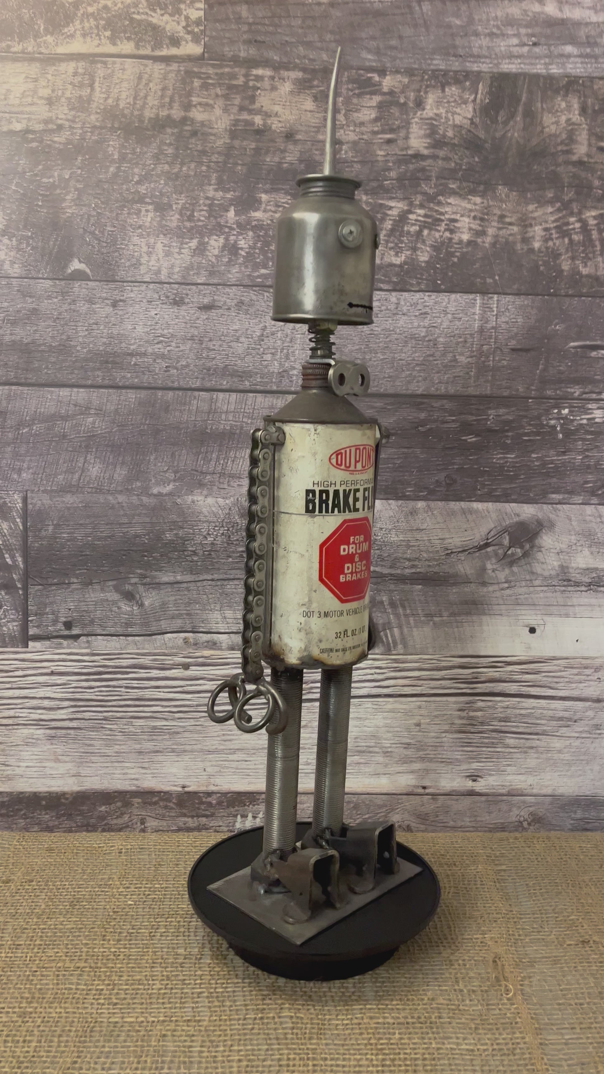 Meet Dupont! This one-of-a-kind robot scrap art sculpture is made from a vintage brake fluid oil tin body, vintage oiler head with uniquely reimagined scrap metal arms and legs.  This big guy is sure to turn heads and stop people in their tracks!  See video for a 360-degree view!  Features:   Height: 63 cm or 24.75 inches tall Width: approximately 15 cm or 6 inches wide Weight: 2.81227 kg or 6.2 lbs