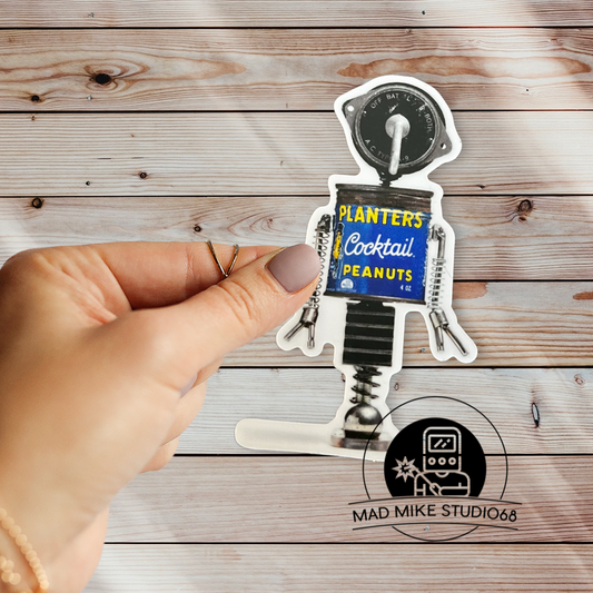 This cute little custom die cut robot scrap art sticker is made of permanent white semi gloss vinyl and measures as follows:  Features:  Metric: 5 cm wide x 8.5 cm tall Imperial: 2 inches wide x 3.5 inches tall Collect them all!