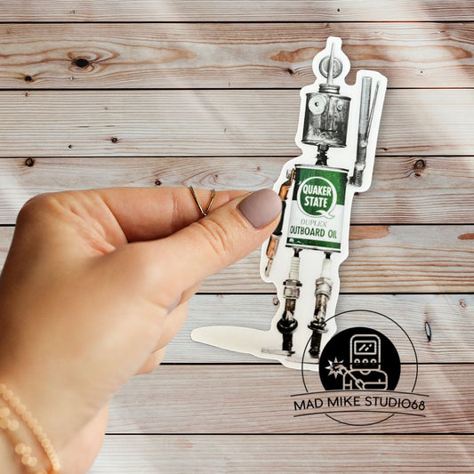 This cute little custom die cut robot scrap art sticker is made of permanent white semi gloss vinyl and measures as follows:  Features:  Metric: 3.175 cm wide x 9.525 cm tall Imperial: 1.25 inches wide x 3.75 inches tall Collect them all!