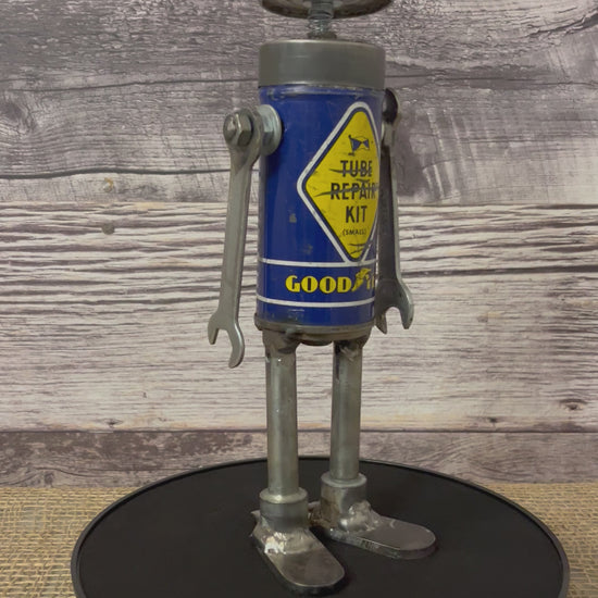 Meet Tubie! This one-of-a-kind robot scrap art sculpture is made from a vintage bicycle tube repair kit tin body, a vintage mini oiler head with uniquely reimagined scrap metal arms and legs. This little bot is a real cutie!   See video for 360 degree view!  Features:   Height: 29 cm or 11.5 inches tall Width: approximately 8 cm or 3.25 inches wide Weight: 0.635029 kg or 1.4 lbs