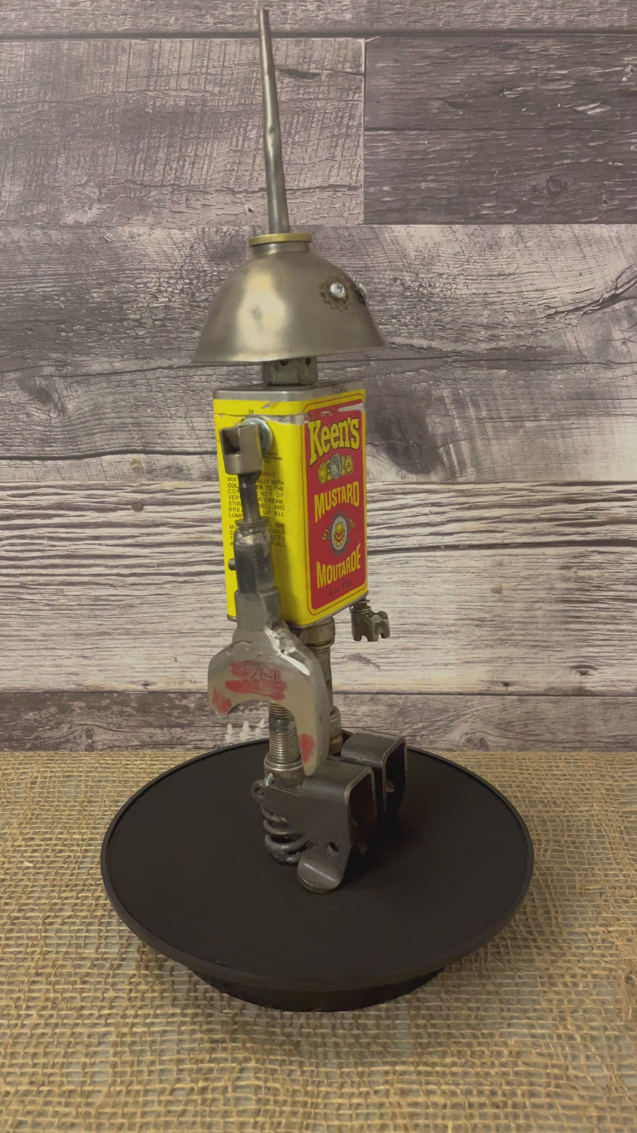 Meet Keener! This one-of-a-kind robot scrap art sculpture is made from a vintage spice tin body, vintage oiler head with uniquely reimagined scrap metal arms and spark plug legs. This adorable little scrap bot is beaming with personality!  See video for a 360-degree view!  Features:   Height: 36 cm or 14 inches tall Width: approximately 10 cm or 4 inches wide Weight: .907 kg or 2 lbs