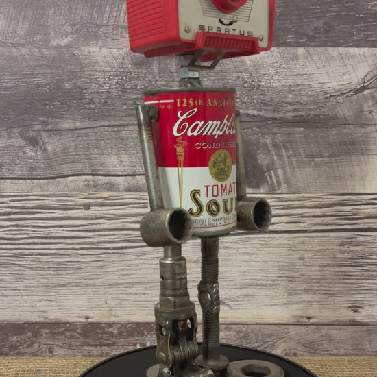 Meet Joe Campbell! This one-of-a-kind robot scrap art sculpture is made from a vintage anniversary soup tin body, vintage Vanguard Spartus camera head with uniquely reimagined scrap metal arms and legs. This adorable little scrap bot is sure to brighten any day!  See video for a 360-degree view!  Features:   Height: 34 cm or 13.5 inches tall  Width: approximately 15 cm or 6 inches wide Weight: 1.4515 kg or 3.2 lbs