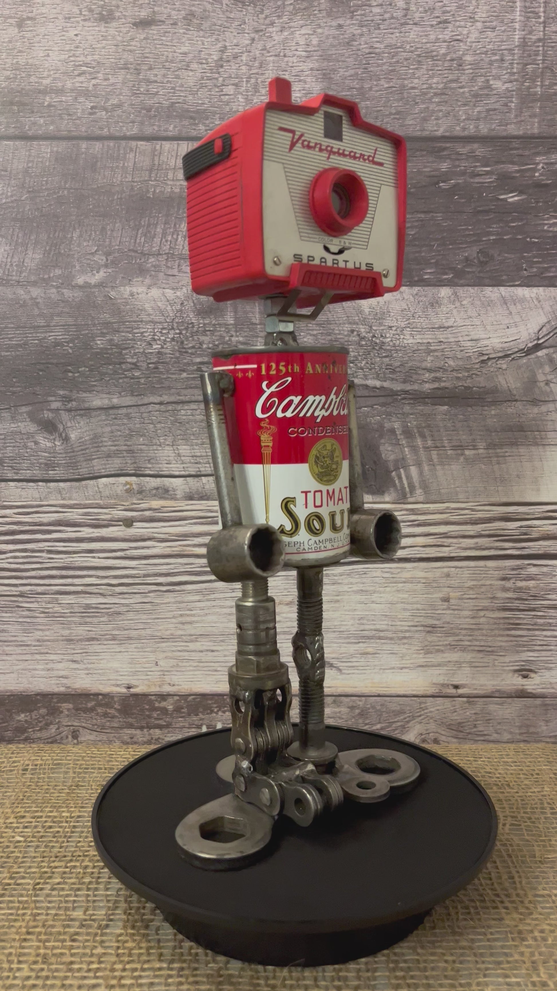 Meet Joe Campbell! This one-of-a-kind robot scrap art sculpture is made from a vintage anniversary soup tin body, vintage Vanguard Spartus camera head with uniquely reimagined scrap metal arms and legs. This adorable little scrap bot is sure to brighten any day!  See video for a 360-degree view!  Features:   Height: 34 cm or 13.5 inches tall  Width: approximately 15 cm or 6 inches wide Weight: 1.4515 kg or 3.2 lbs