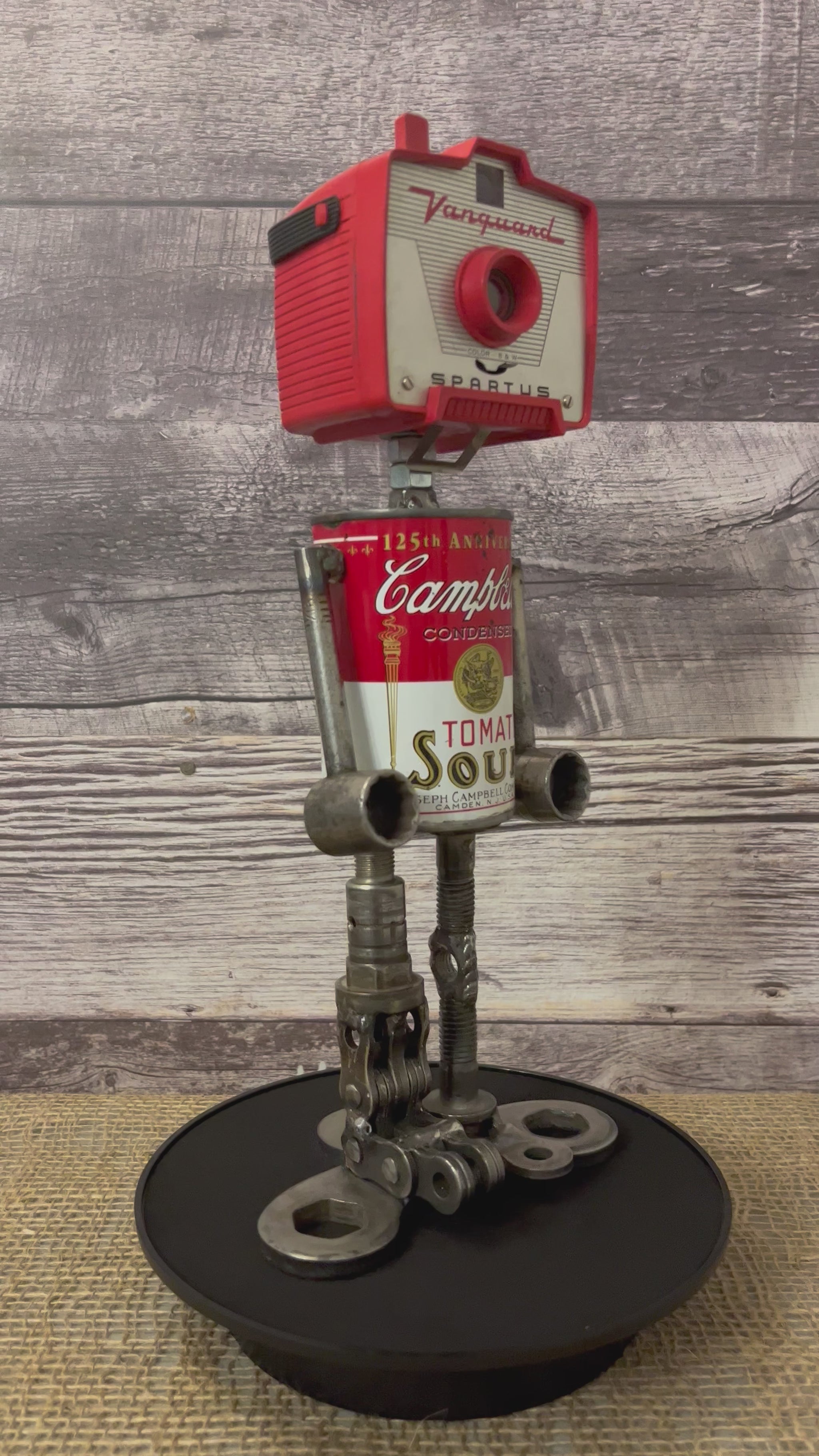 Meet Joe Campbell! This one-of-a-kind robot scrap art sculpture is made from a vintage anniversary soup tin body, vintage Vanguard Spartus camera head with uniquely reimagined scrap metal arms and legs. This adorable little scrap bot is sure to brighten any day!  See video for a 360-degree view!  Features:   Height: 34 cm or 13.5 inches tall  Width: approximately 15 cm or 6 inches wide Weight: 1.4515 kg or 3.2 lbs